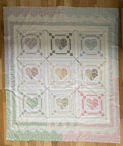Patchwork quilt with hearts in pastel colors and white
